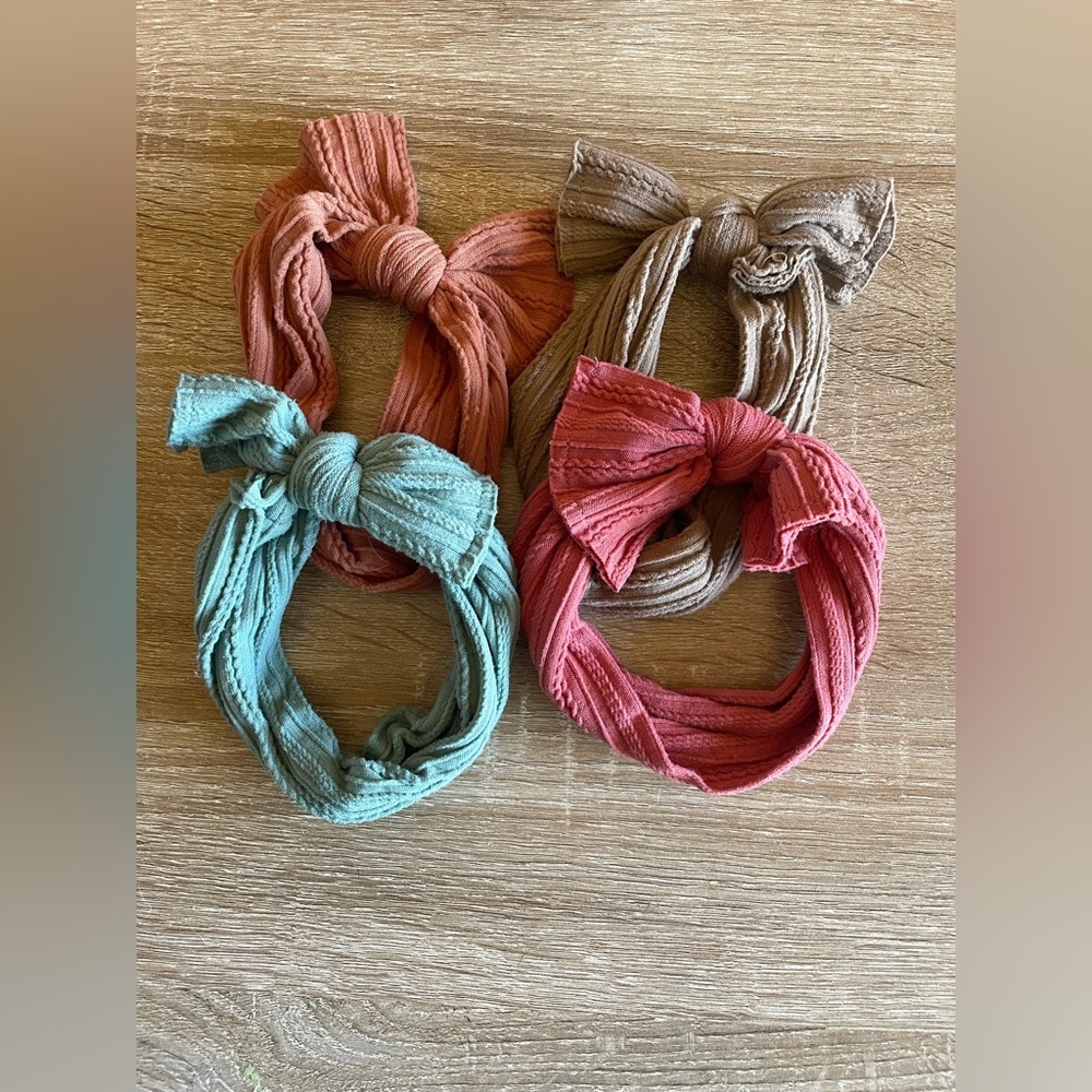 Lot of ribbed knit baby or toddler headbands with a bow detail earth tones